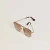 Aviator-style sunglasses with gold frame and beige lenses