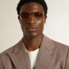 Aviator-style sunglasses with gold frame and beige lenses