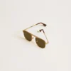 Aviator style sunglasses with gold frame and green lenses