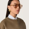 Aviator style sunglasses with honey-colored frame and lenses