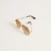 Aviator style sunglasses with rose-gold frame and honey-colored lenses