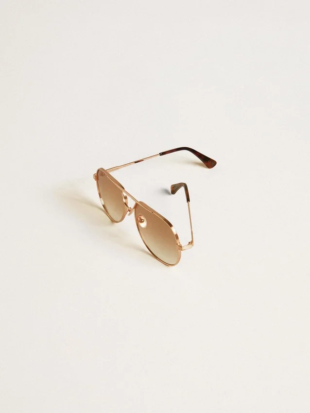 Aviator style sunglasses with rose-gold frame and honey-colored lenses