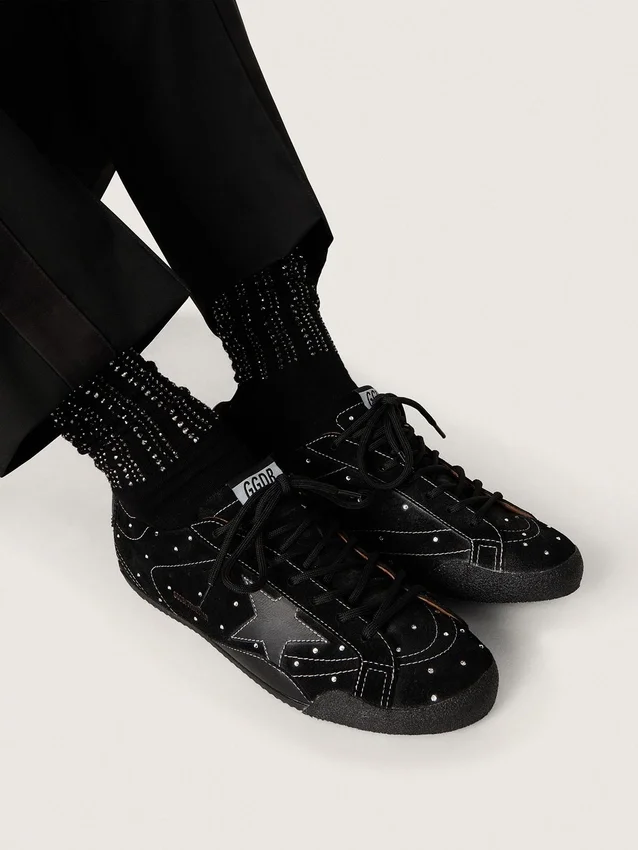 Black socks with distressed details and rhinestones