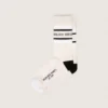 Blush-colored socks with distressed details and black and white stripes
