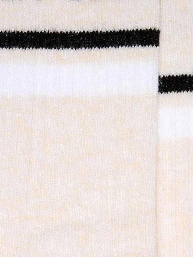 Blush-colored socks with distressed details and black and white stripes