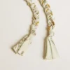 Butter-colored braided fabric charm with brass chain