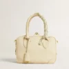 Butter-colored braided fabric charm with brass chain