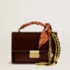 Charm with yellow and brown knotted hiking laces with chain