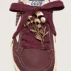 CNY Skins laces in burgundy wool with gold flower pin