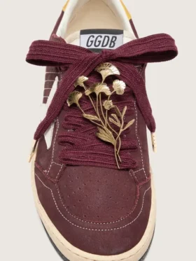 CNY Skins laces in burgundy wool with gold flower pin