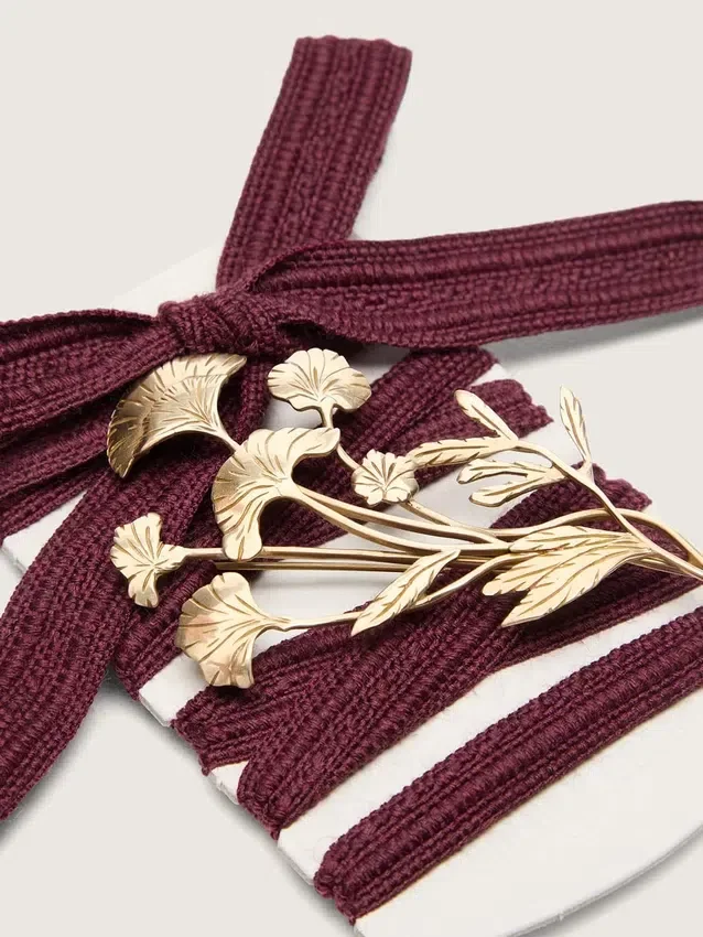 CNY Skins laces in burgundy wool with gold flower pin