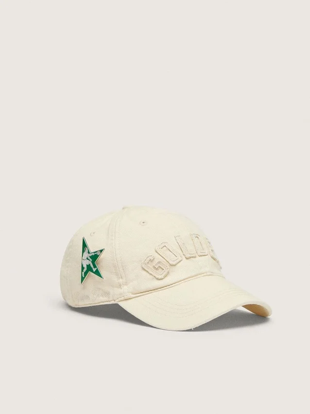 Cream baseball cap with tone-on-tone "Golden" patch and green star pin