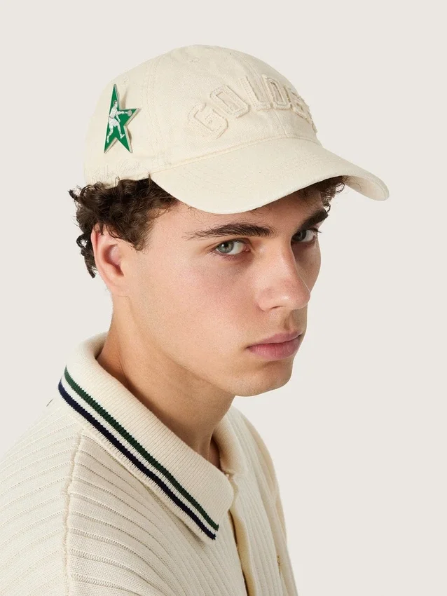 Cream baseball cap with tone-on-tone "Golden" patch and green star pin