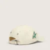 Cream baseball cap with tone-on-tone "Golden" patch and green star pin