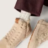Cream-colored socks with distressed details and rhinestones