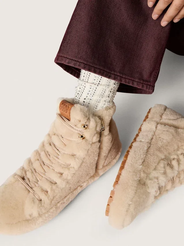 Cream-colored socks with distressed details and rhinestones