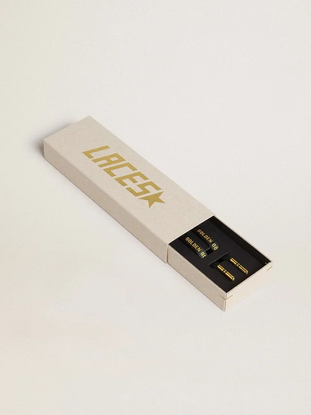 Dark green cotton laces with contrasting gold-colored logo