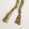 Dove-gray braided fabric charm with brass chain