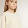 Girls’ cream-colored sweatshirt with patch writing