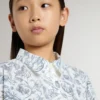 Girls’ shirt dress in white cotton canvas with a blue nautical print and white piping