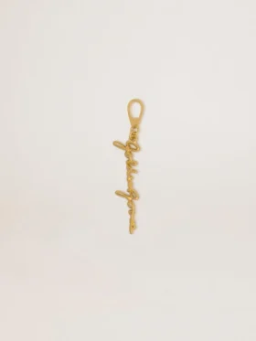 Gold-colored brass charm with Golden Goose signature