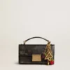 Gold-colored brass charm with Golden Goose signature