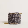 Gray and black animal-print laces with contrasting gold logo