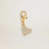 Heart-shaped charm in gold-colored brass with crystals