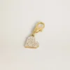 Heart-shaped charm in gold-colored brass with crystals