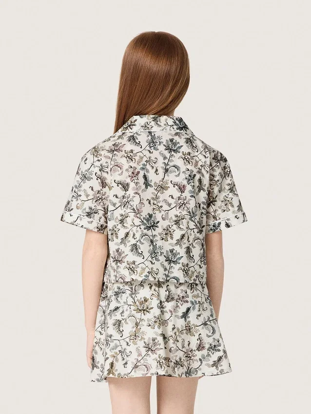 Journey girls’ short-sleeved shirt in white cotton canvas with a green floral print