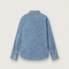 Journey unisex shirt in light blue cotton chambray with fringed hem and embroidered patch