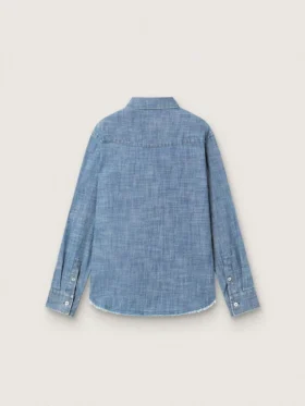 Journey unisex shirt in light blue cotton chambray with fringed hem and embroidered patch