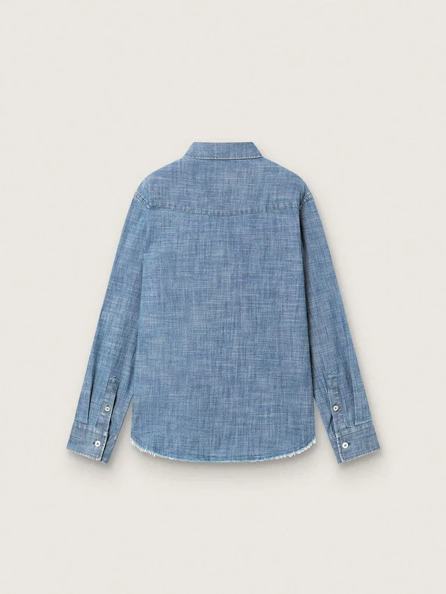 Journey unisex shirt in light blue cotton chambray with fringed hem and embroidered patch