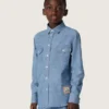 Journey unisex shirt in light blue cotton chambray with fringed hem and embroidered patch