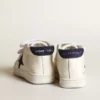 June Junior in nappa with dark blue suede star and heel tab