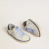 Junior Super-Star in white leather with blue suede heel tab