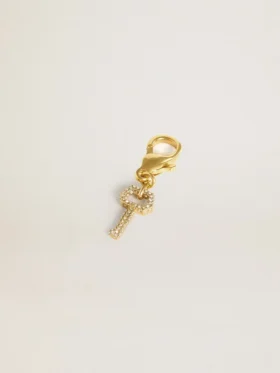 Key-shaped charm in gold-colored brass with crystals