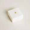 Key-shaped charm in gold-colored brass with crystals