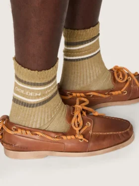 Khaki-colored socks with distressed details and dark green and white stripes