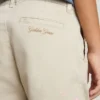 Kids’ beige chino pants with multicolor splashes
