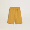 Kids jogging shorts in ochre yellow with embroidery