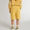 Kids jogging shorts in ochre yellow with embroidery