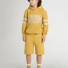Kids jogging shorts in ochre yellow with embroidery