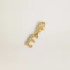 Letter E charm in gold-colored brass with crystals