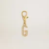 Letter G charm in gold-colored brass with crystals
