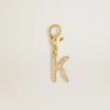 Letter K charm in gold-colored brass with crystals