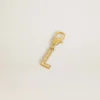 Letter L charm in gold-colored brass with crystals