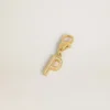 Letter P charm in gold-colored brass with crystals