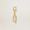 Letter Q charm in gold-colored brass with crystals