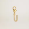 Letter U charm in gold-colored brass with crystals